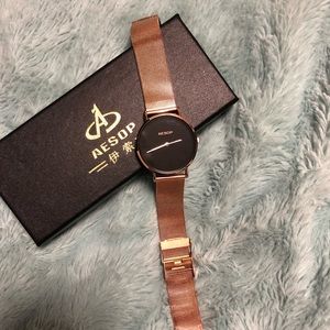 Women’s thin rose gold and black watch